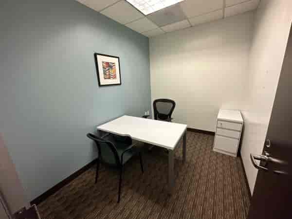 Minimalist meeting room with two chairs for intimate discussions and brainstorming sessions.