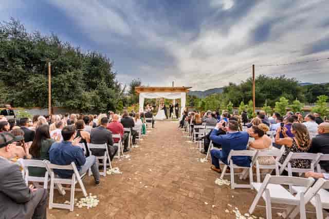 Outdoor wedding ceremony at The Galleria, featuring an elegant floral archway.