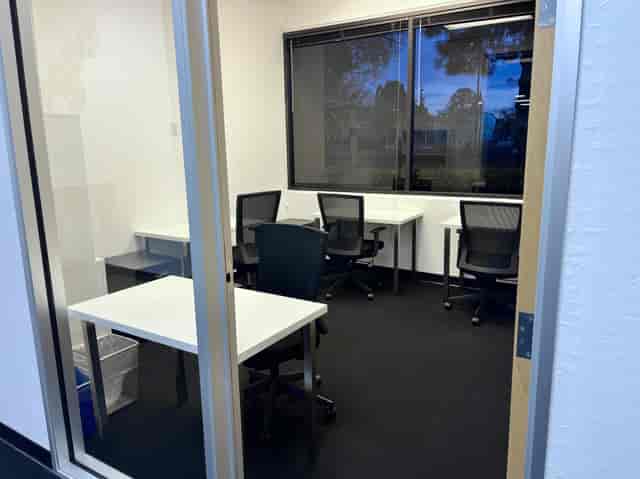 Modern minimalist meeting space with flexible desks for collaboration and brainstorming.