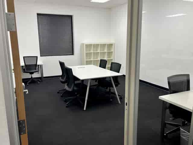 Modern minimalist meeting room with ergonomic chairs for collaborative brainstorming sessions.