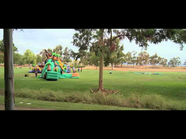 Spacious outdoor venue with inflatables for family-friendly events and festivals.
