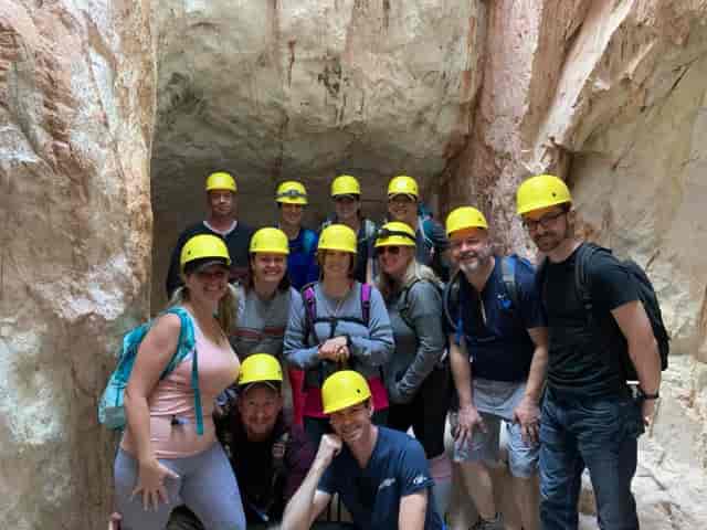 Group in helmets at Santa Clara cave for adventurous team-building event.
