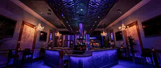 Elegant OPAL Nightclub bar with purple lighting, perfect for cocktail receptions and networking.