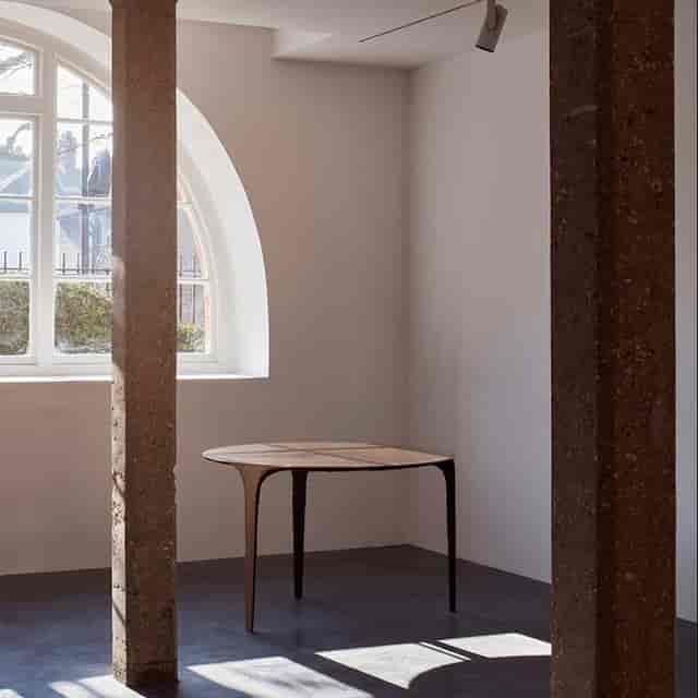 Minimalist meeting space in Ladbroke Hall with modern table and natural light for creative events.