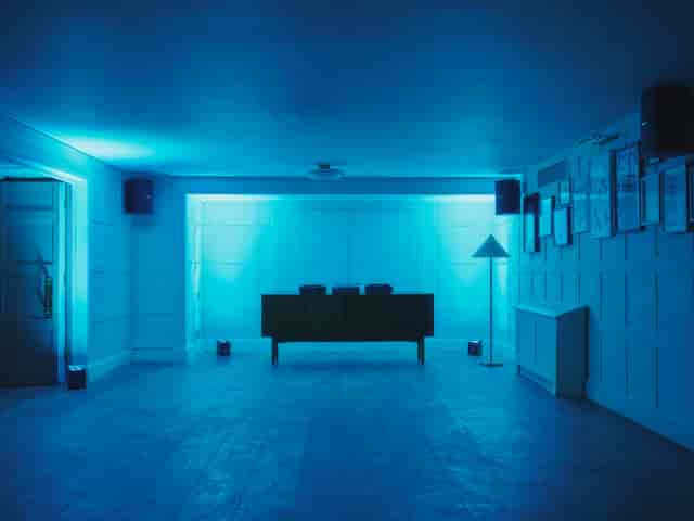 Modern event space with blue lighting, perfect for gatherings and meetings.