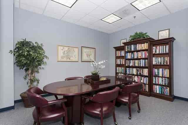 Meeting room with round table and chairs for collaborative brainstorming sessions.