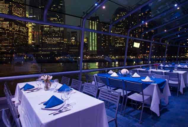 Elegant boat dining setup with blue accents for upscale fundraisers and galas.