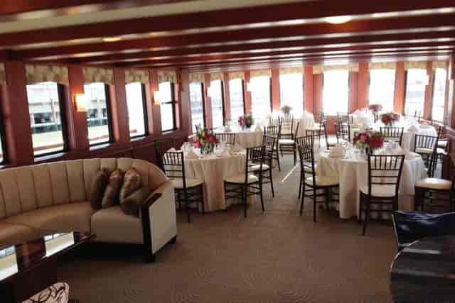 Elegant event space with round tables and floral centerpieces for corporate meetings.