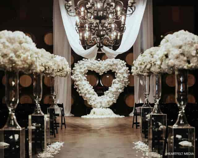 Elegant heart-shaped floral arrangement in Palm Event Center wedding setup.