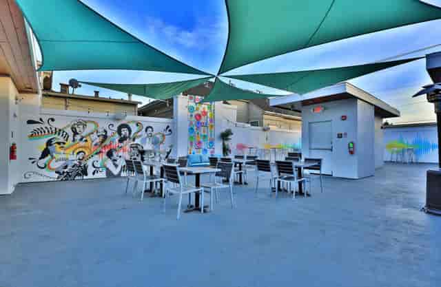 Vibrant rooftop lounge with colorful murals for casual gatherings and networking events.