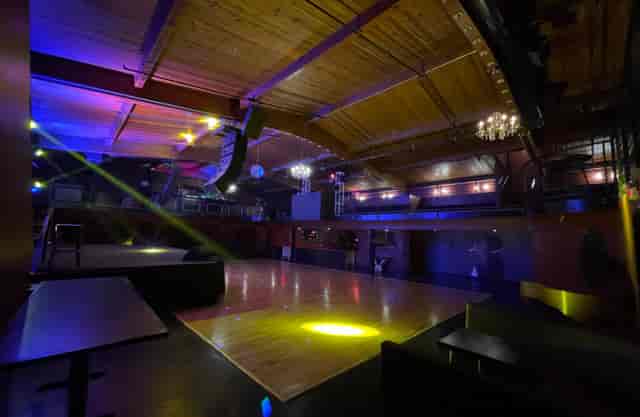 Lounge area in Continental Club with wooden floor, ideal for events and performances.