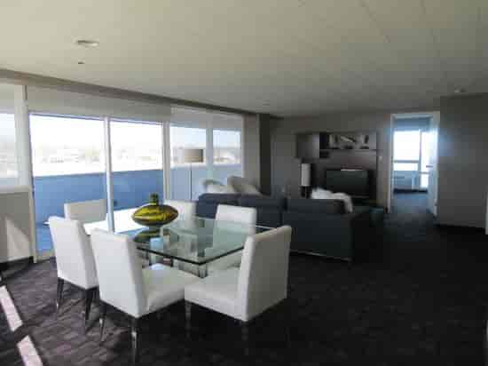 Modern meeting space in Oyster Point Hotel with glass table and natural light.