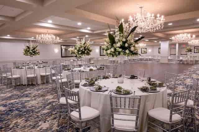 Elegant ballroom with floral centerpieces, perfect for weddings and corporate events.