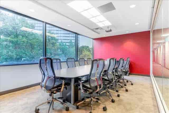 Modern conference room with large table, ideal for meetings and presentations.