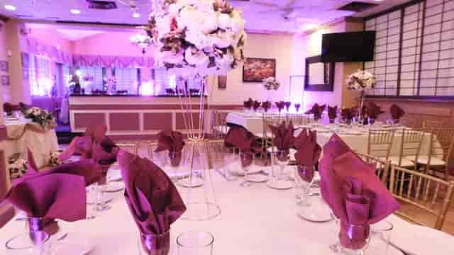 Elegant party room with purple napkins, perfect for weddings and formal events.