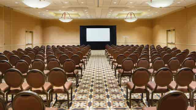 Meeting room with brown chairs and central screen in Atlantic City Convention Center.