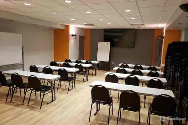 Versatile NYC conference room setup for workshops and seminars with ample lighting.