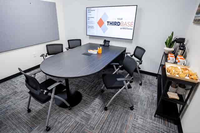 Modern meeting room with oval table, ideal for corporate events and presentations.