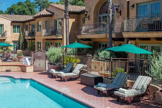 Poolside patio at Los Gatos Lodge with lounge chairs, perfect for networking events.