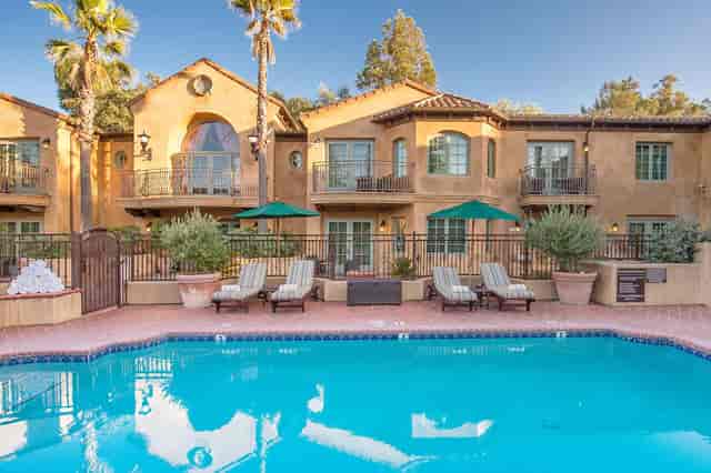 Poolside patio at Los Gatos Lodge, ideal for events with serene pool and lounge chairs.