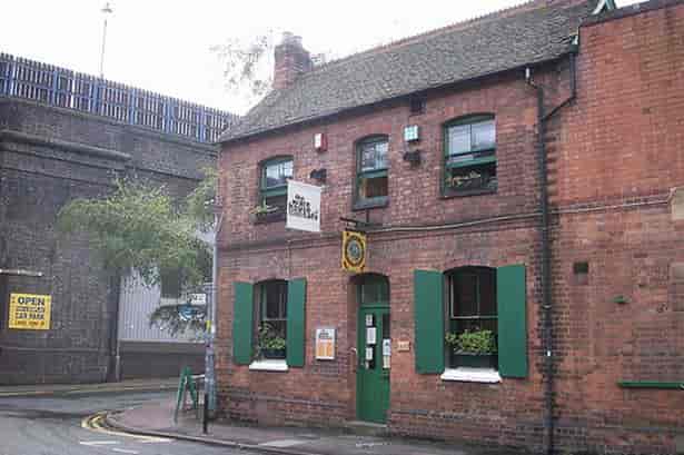 Charming brick cafe venue with green accents for intimate meetings and events.
