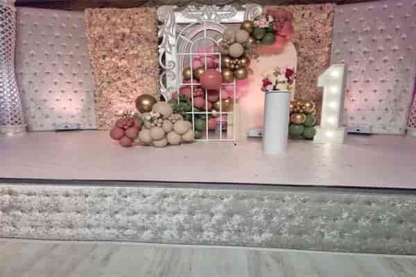 Elegant birthday party hall with floral backdrop and plush seating in Digbeth.