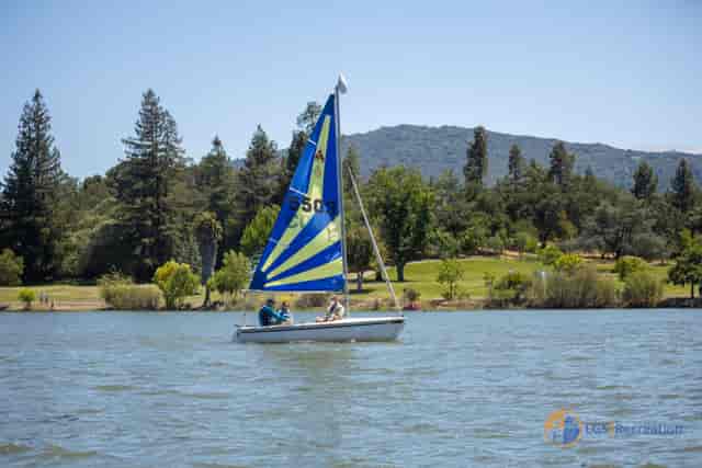 Sailing camp in Los Gatos with a sailboat on calm waters, ideal for team-building events.