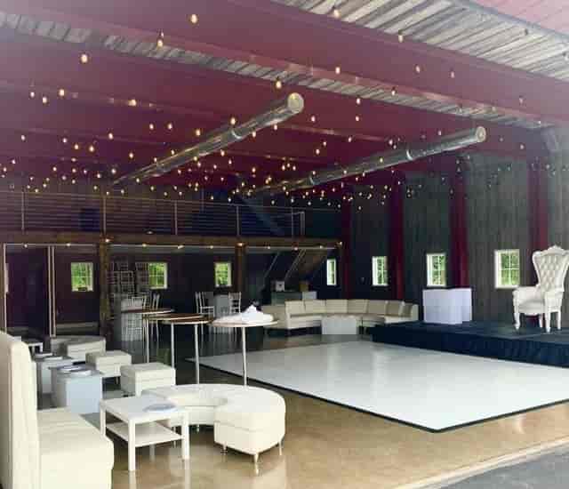 Outdoor party space with modern furnishings and ambient lighting for events and celebrations.