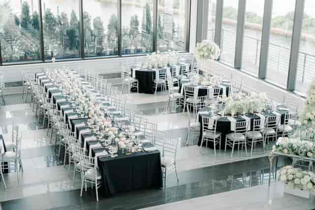 Elegant banquet hall setup with black and white decor for corporate events.