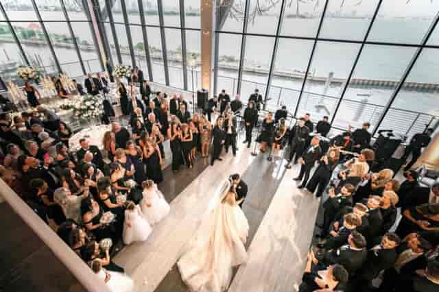 Elegant wedding ceremony on a dance floor at Hudson House with waterfront views.