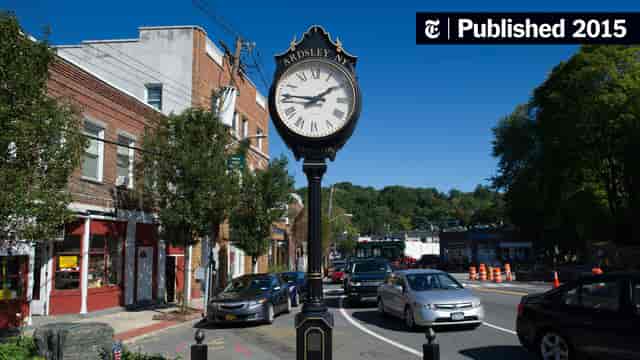 "Charming Ardsley Community Center with vintage clock, ideal for outdoor events and gatherings."