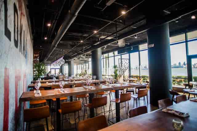 Indoor dining area with large windows at Lokal Eatery & Bar for events and gatherings.