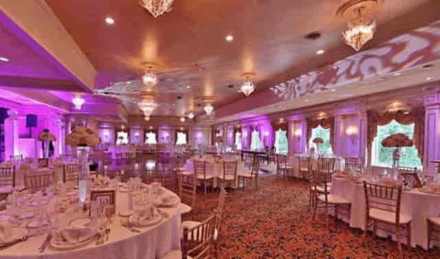 Elegant wedding venue with purple lighting and chandeliers in Il Tulipano garden.