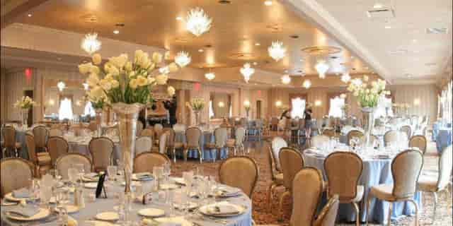 Elegant banquet hall with floral centerpieces for weddings and corporate events.