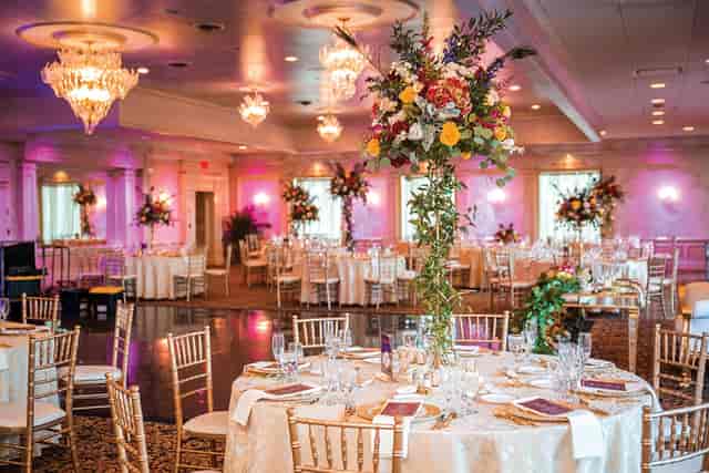 Elegant ballroom with floral centerpieces, ideal for weddings and formal events.