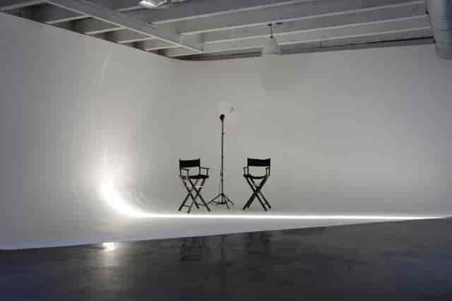 Minimalist event space with director's chairs, ideal for interviews and video shoots.