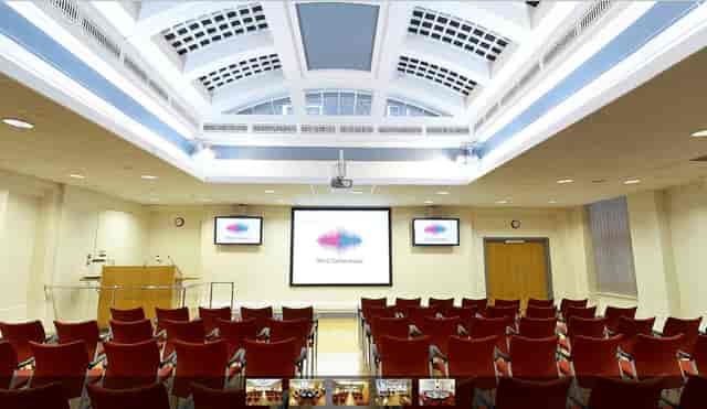 Conference room with red seating, ideal for meetings and events at W12 Conferences.