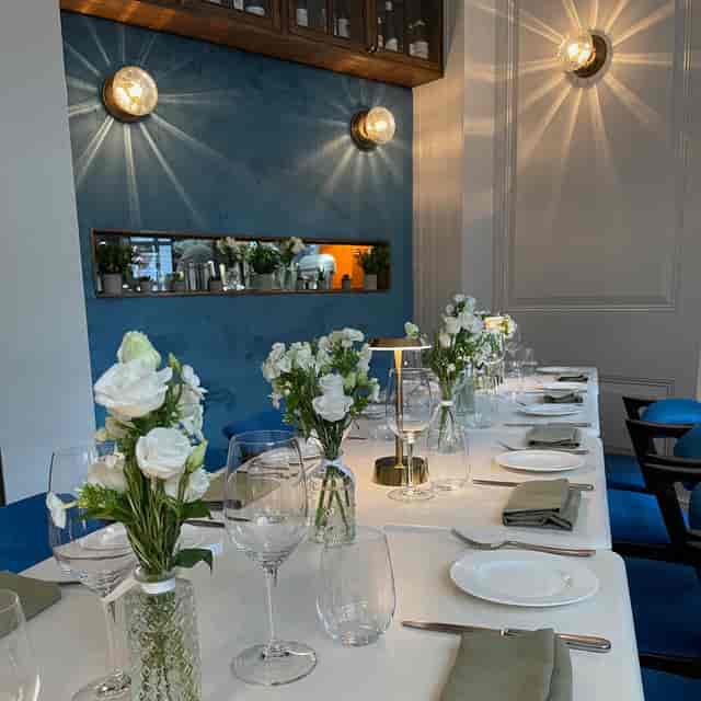 Elegant dining table with white flowers in 104 Restaurant for corporate events or celebrations.