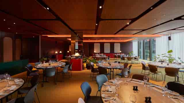 Modern event space with round tables, ideal for corporate events and private celebrations.