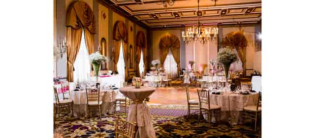 Elegant event space with round tables, ideal for weddings and corporate events.