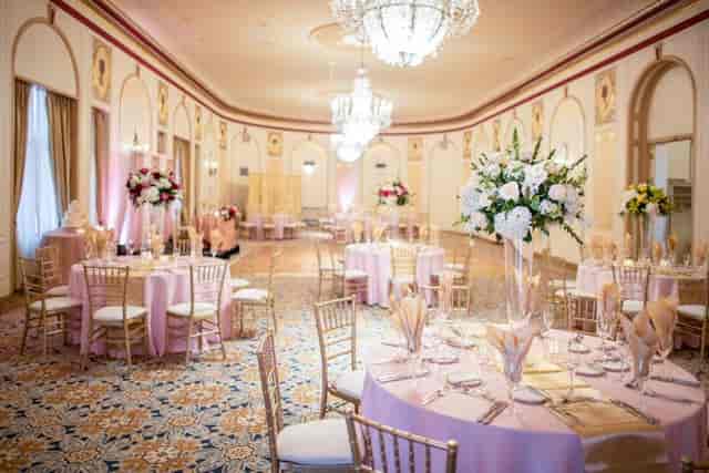 Elegant Crystal Ballroom with pink linens, ideal for weddings and corporate events.