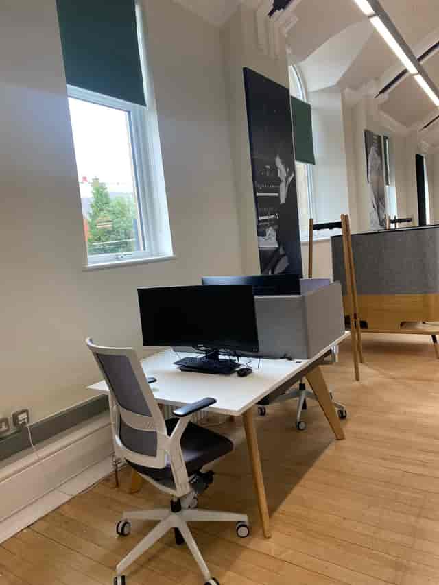 Modern office workspace with dual monitors, ideal for hybrid meetings and events.