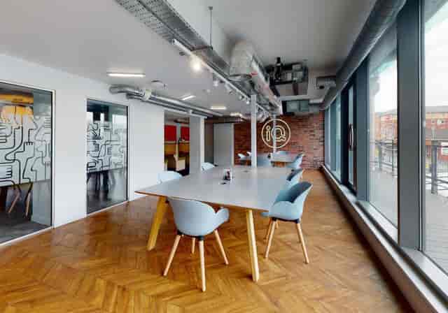 Modern meeting space in Wilmslow Conference Centre with spacious table and natural light.