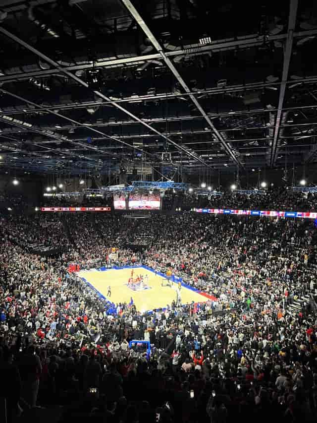 Packed basketball court at Accor Arena during a high-energy game, showcasing sports marketing.