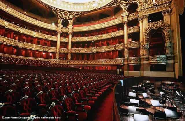 Grand theater interior with plush red seating, perfect for elegant events in Paris.
