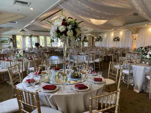 Elegant wedding ceremony site at Saratoga Country Club with lush floral centerpieces.