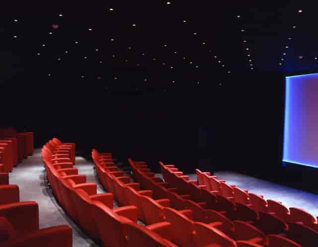 Modern screening room at The Soho Hotel with red seating, ideal for corporate events.