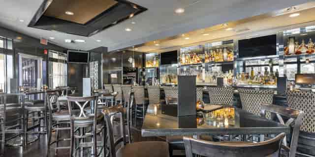 Modern outdoor patio bar at Morton's The Steakhouse for events and gatherings.