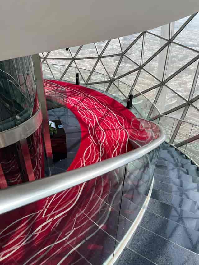 360 Lounge staircase with red carpet, modern venue for networking events in Riyadh.
