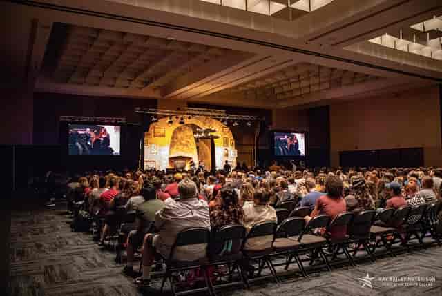"Ballroom A at Kay Bailey Hutchison Convention Center with audience at a conference presentation."